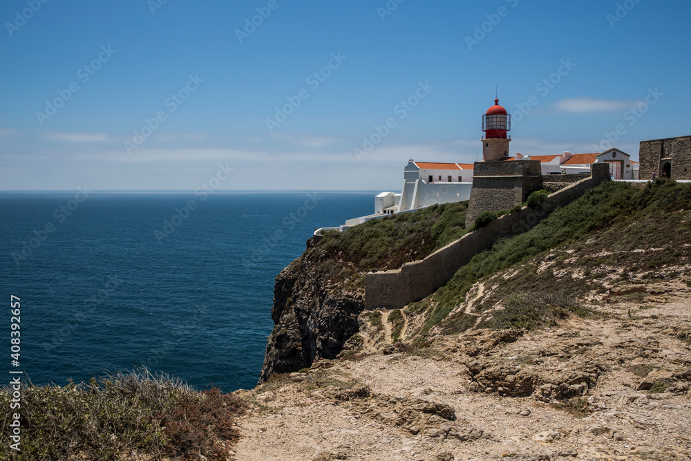 Rocky Coastline And Lighthouse At Cabo De Sao Vicente, Algarve, Portugal, Europe