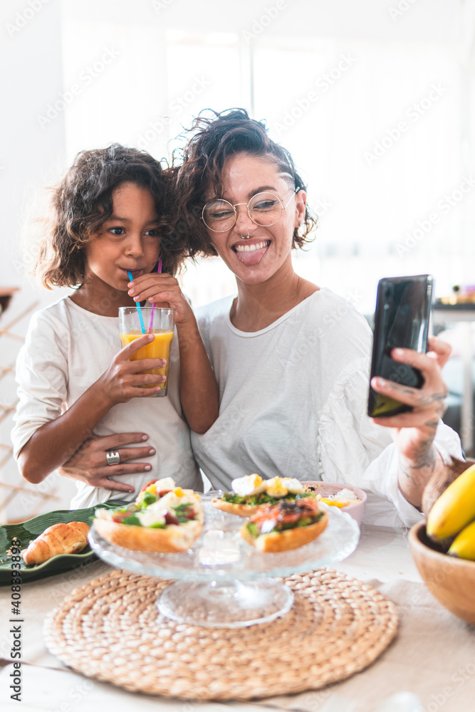 Mother and daughter taking selfie during breakfast Mother and daughter taking selfie during breakfast