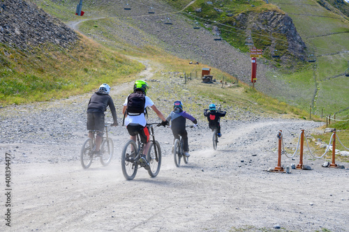 Extreem outdoor sport challenge in French Alps mountains in summer, riding downhill on sport bike on special bicycle path