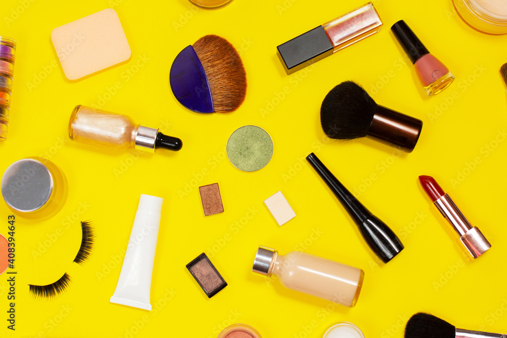 Obraz premium Set of decorative cosmetics on yellow background. Makeup cosmetics tools background