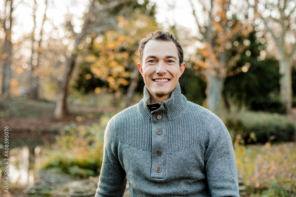 Smiling handsome man sitting in public park Smiling handsome man sitting in public park
