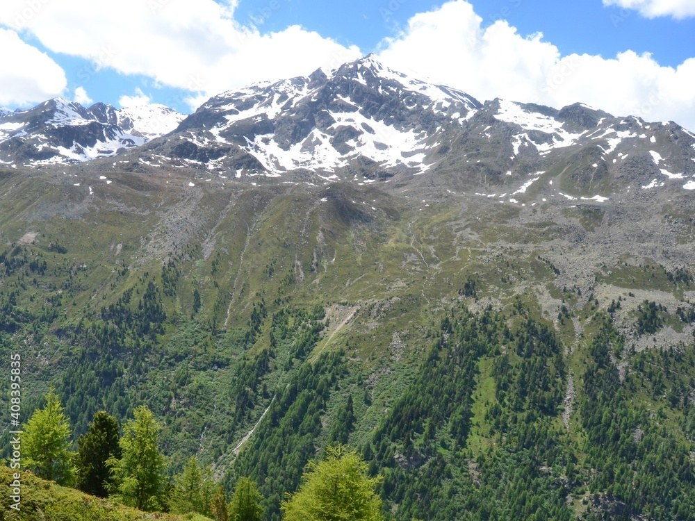 Obraz premium Mountainous landscape with freshly snow covered steppe-like botany partly wooded wide view into the country on which a road leads