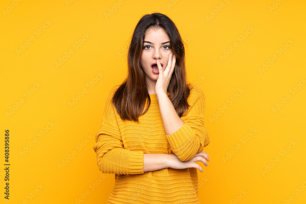 Young caucasian woman isolated on yellow background surprised and shocked while looking right Young caucasian woman isolated on yellow background surprised and shocked while looking right