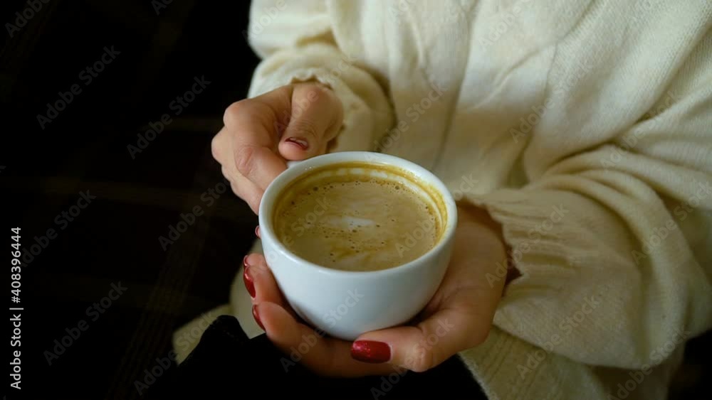 Cup with cappuccino in female hands Cup with cappuccino in female hands