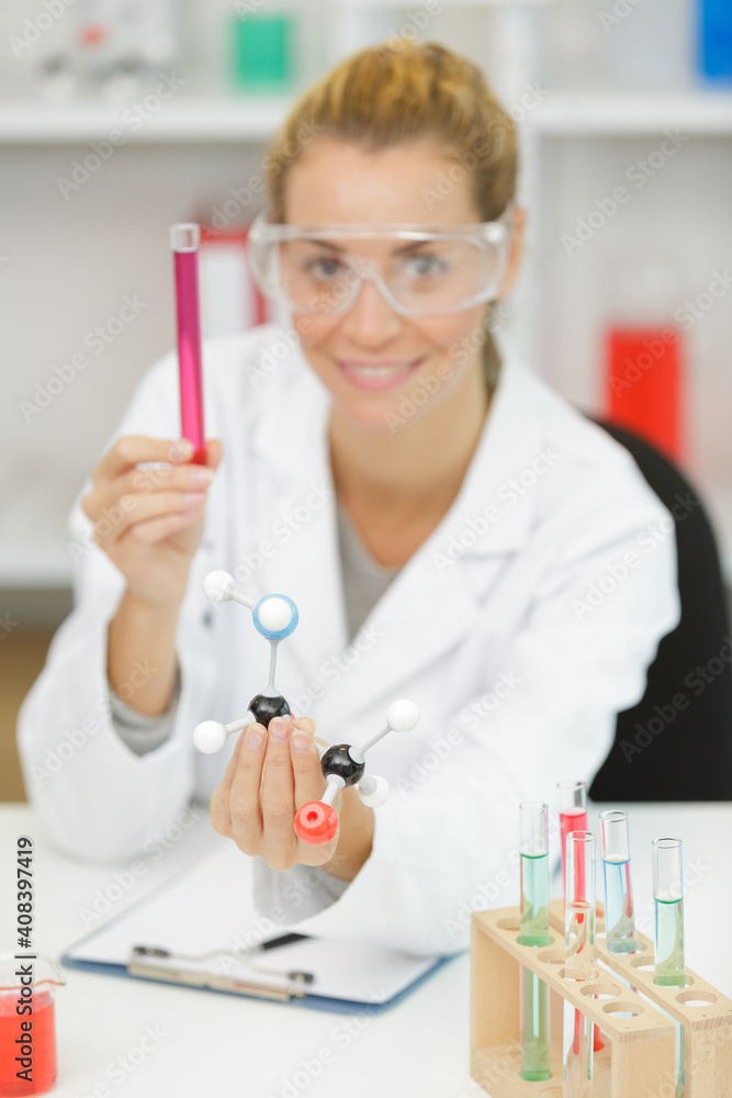 woman with a pipette in her hands a green liquid woman with a pipette in her hands a green liquid