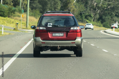 P Plater driving on sealed road in suburban area