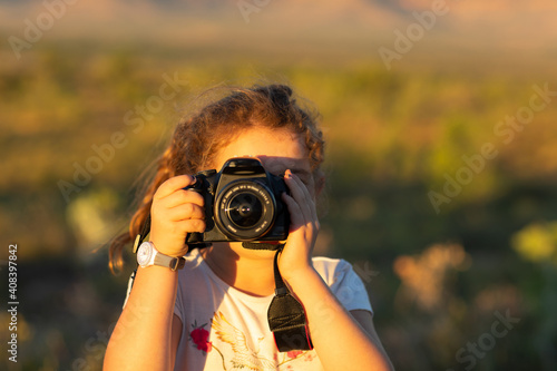 child looking through DSLR camera taking photo of viewer photo