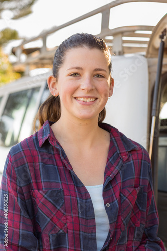 Smiling young woman wearing flannel shirt