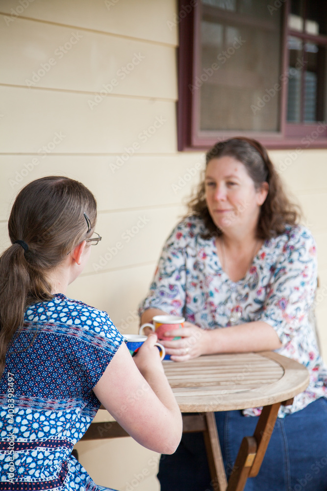 Mother and daughter sitting together talking Mother and daughter sitting together talking
