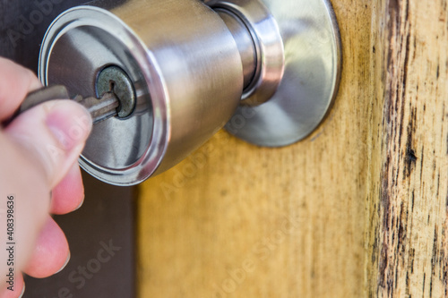 Close up of a key in a door handle of a house