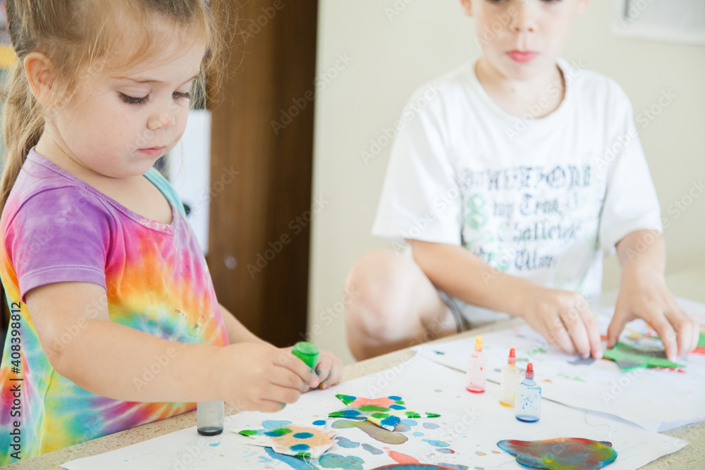 Kids doing colourful Christmas craft with food colouring paint Kids doing colourful Christmas craft with food colouring paint