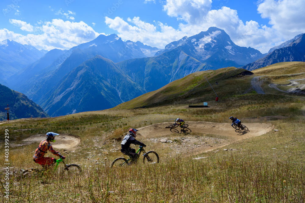 Extreem outdoor sport challenge in French Alps mountains in summer, riding downhill on sport bike on special bicycle path Extreem outdoor sport challenge in French Alps mountains in summer, riding downhill on sport bike on special bicycle path