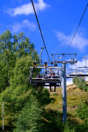 Extreem outdoor sport challenge in French Alps mountains in summer, using lift for riding downhill on sport bike on special bicycle path