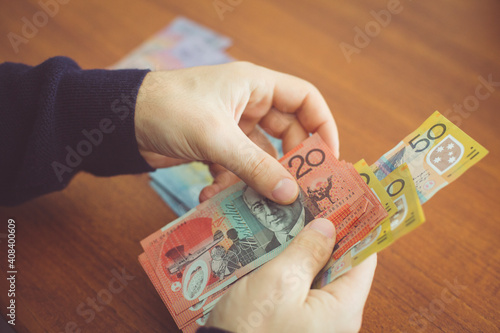 Hands counting money on the table photo