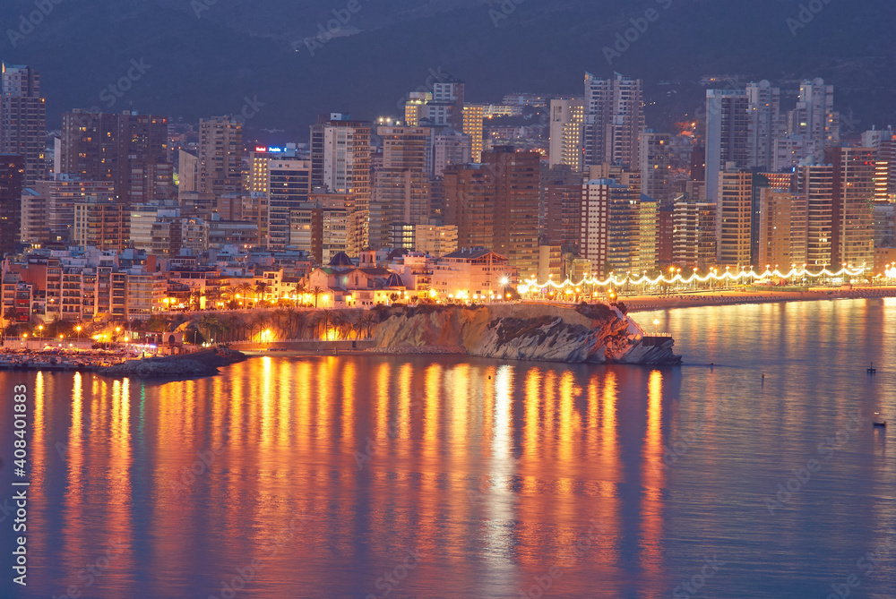 Fototapeta premium top view of the beach, buildings and illuminations in the evening at Playa de Levante and Playa de Poniente beach in Benidorm, Spain
