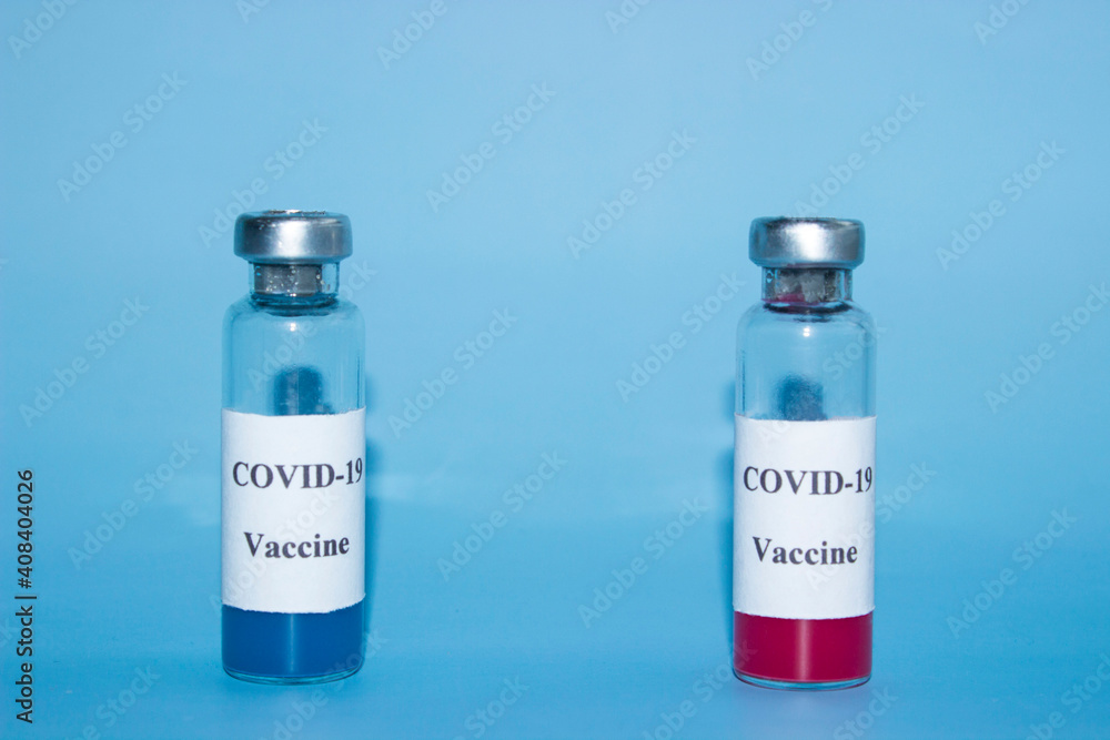 Two vials with a vaccine on a blue background. Red and blue. Choice. High quality photo Two vials with a vaccine on a blue background. Red and blue. Choice. High quality photo