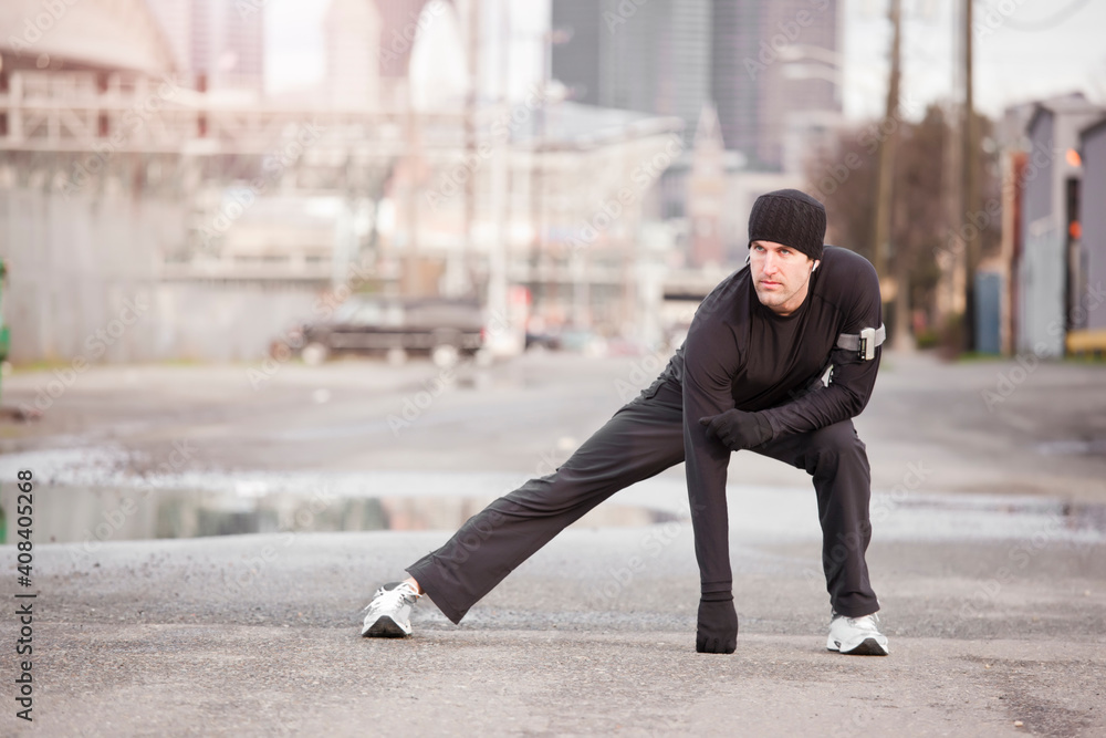 USA, Washington, Seattle, man stretching in street USA, Washington, Seattle, man stretching in street