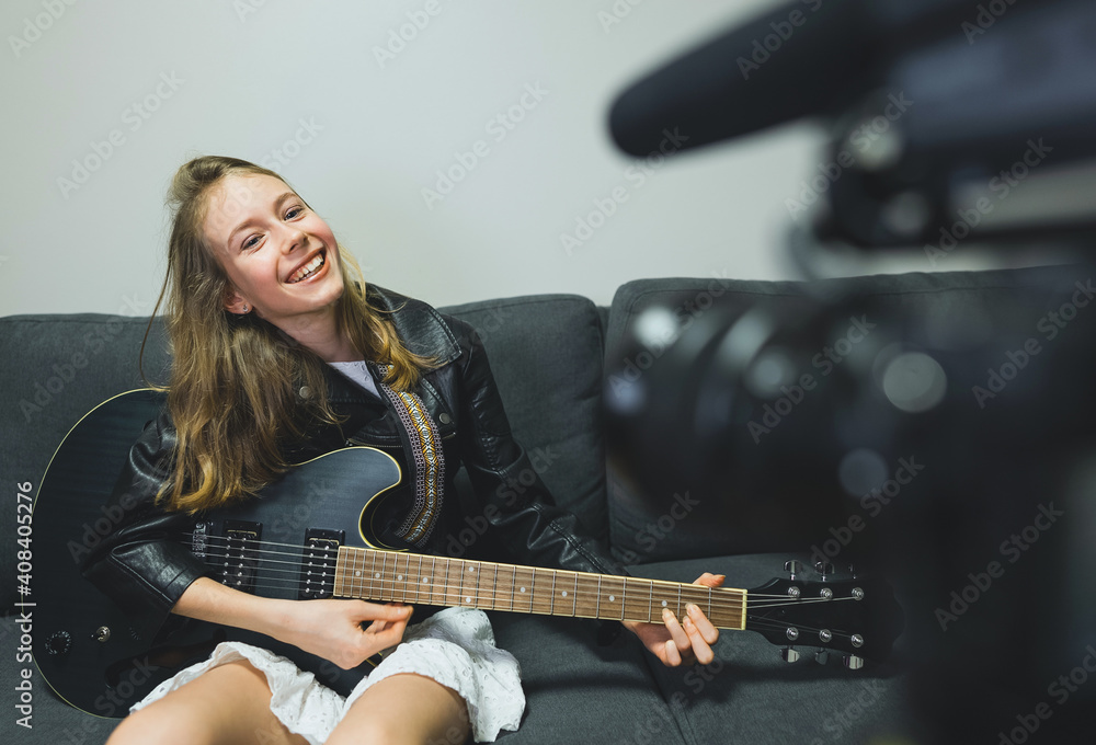 Teenage girl with semi-acoustic guitar in front of the video camera. Teenage girl with semi-acoustic guitar in front of the video camera.