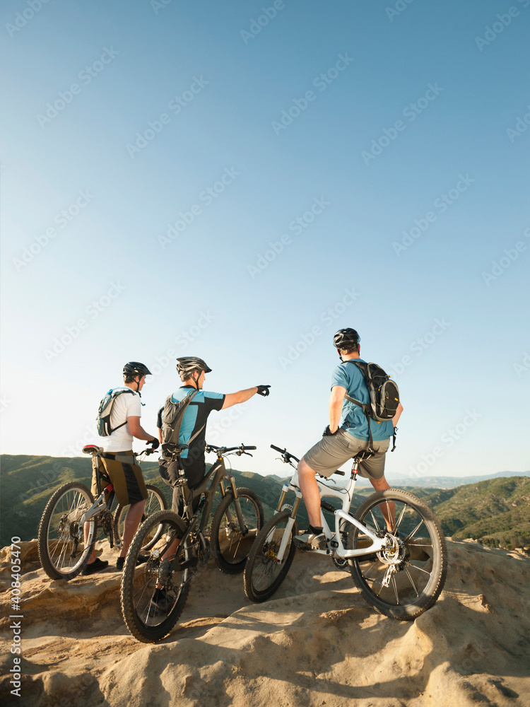 USA, California, Laguna Beach, Two bikers on hill looking at view USA, California, Laguna Beach, Two bikers on hill looking at view