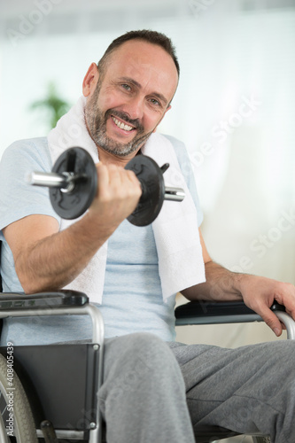 positive man in wheelchair tries to get better