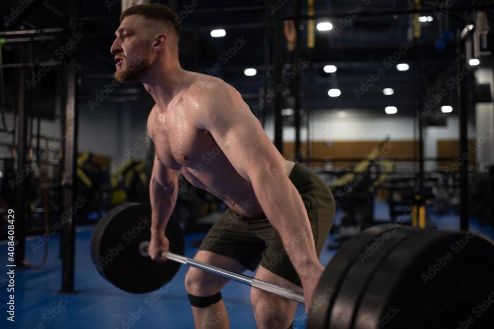 Brutal bodybuilder exercising with barbell Brutal bodybuilder exercising with barbell