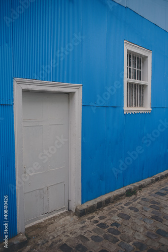 white door in blue wall