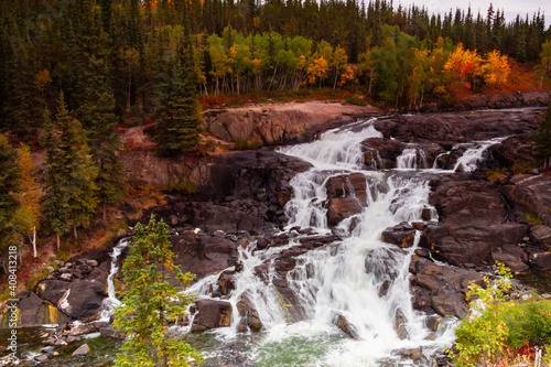 Early fall colours provide contrast to the stark rock framing Cameron falls along the Ingraham Trail in Canada's Northwest Territories photo