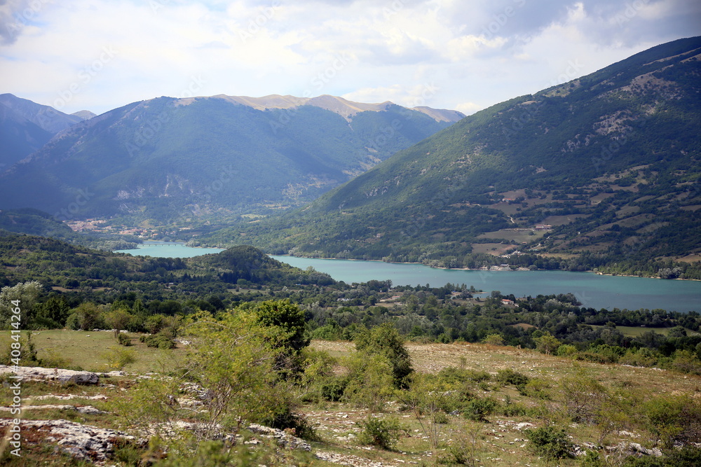 Barrea lake set in the mountains covered with vegetation, Barrea, Abruzzo National Park, Italy