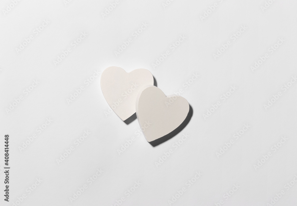 White hearts on the center of white paper background. Valentine Day minimalistic concept