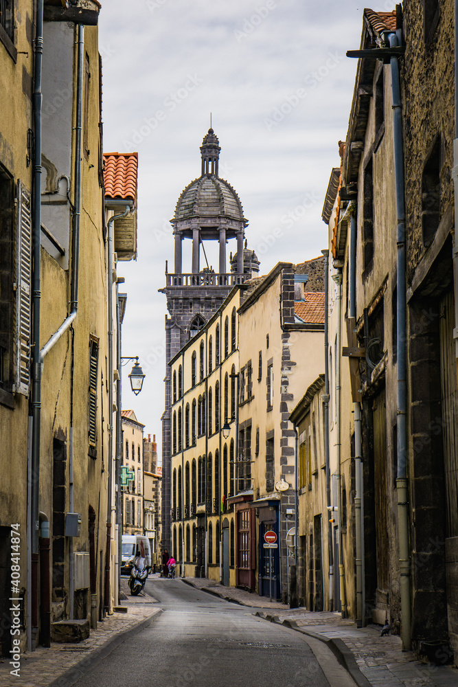 View on Notre Dame de Mathuret church bell tower from Harp street in Riom, a small town in Auvergne (France)