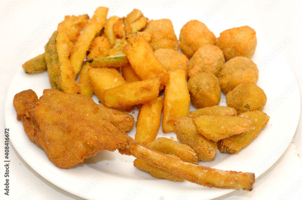 Mixed fried all'ascolana includes olives all'ascolana, artichokes, courgettes, lamb cutlets and fried cream called cremini fritti Mixed fried all'ascolana includes olives all'ascolana, artichokes, courgettes, lamb cutlets and fried cream called cremini fritti
