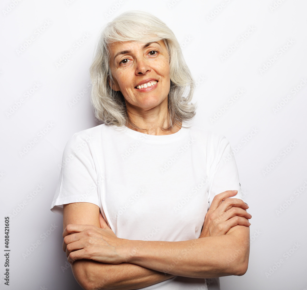 Portrait of senior gray-haired woman with cute smile over white background Portrait of senior gray-haired woman with cute smile over white background