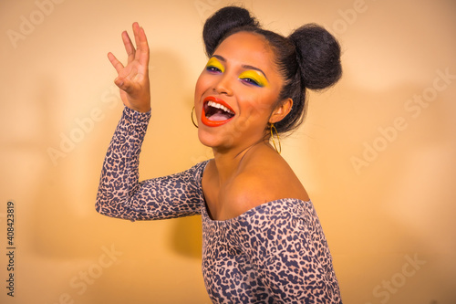 Photography A sexy sensual woman with bright makeup and two side bun hairstyle doing a claw