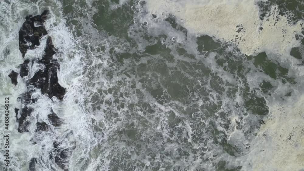 Looking down at ocean waves crashing as drone pulls out, 4k Looking down at ocean waves crashing as drone pulls out, 4k