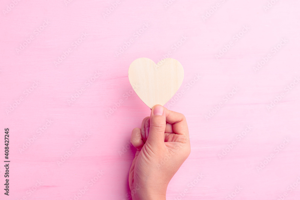 Hand holding heart shape for giving on pink background, Valentine day Hand holding heart shape for giving on pink background, Valentine day