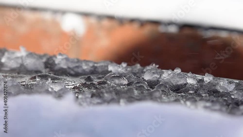 Melt water dripping from a rooftop in the early Spring