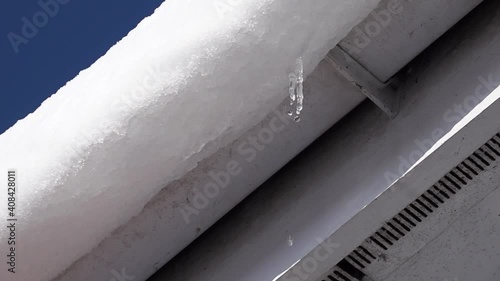 Melt water dripping from a rooftop in the early Spring