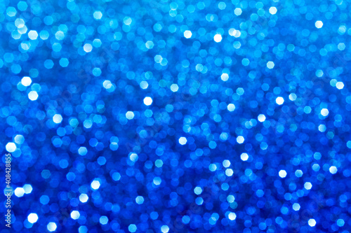 Abstract blue glitter lights background. Circle blurred bokeh. Festive backdrop for Christmas, holiday or event. Winter Card or invitation