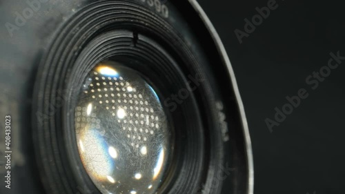 Closer look of the lens of the old vintage camera with the details of the parts of it