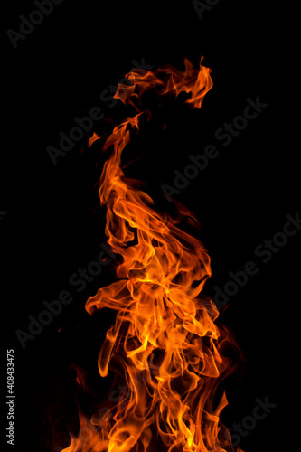 Bright orange red Fire flame against black background, abstract texture