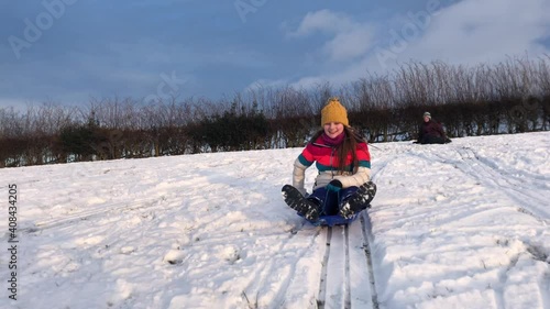 People sledging down a hill on a snowy day in late January 2021
