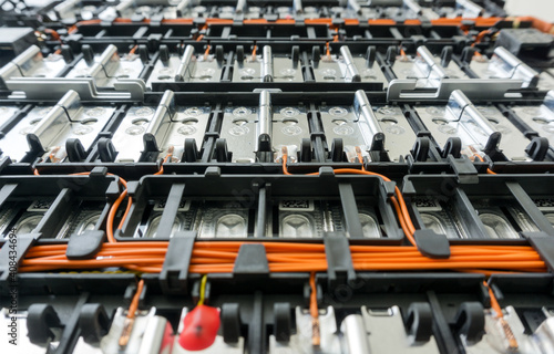 Selective focus of Electric car lithium battery pack and wiring connections internal between cells on background. 