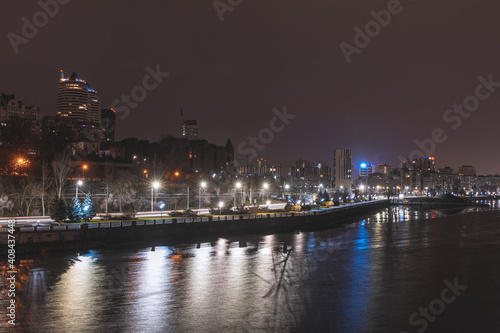 Beautiful city at night. Night city reflected in the water.