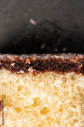 Delectable lamington  made with sponge cake  chocolate sauce and shredded coconut