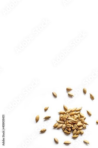 close-up of a pile of organic dry cardamom seeds isolated on a white background
