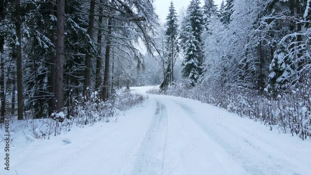 Driving through the forest on snow covered road. Empty road with no traffic. POV Driving through the forest on snow covered road. Empty road with no traffic. POV
