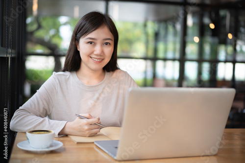 Unrecognizable cheerful young businesswoman reading a message on a smartphone close up.