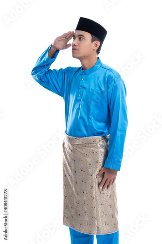 portrait of malaysian male with salute gesture over white background photo