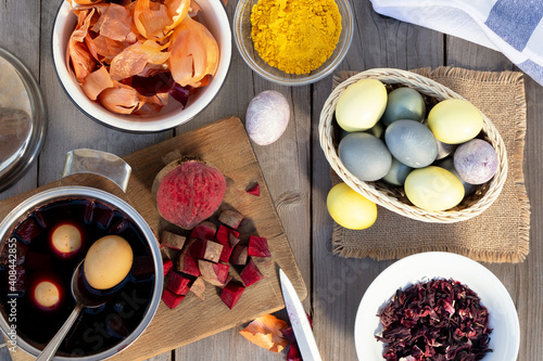 Process of coloring Easter eggs with various food natural dyes. Preparing for Easter.