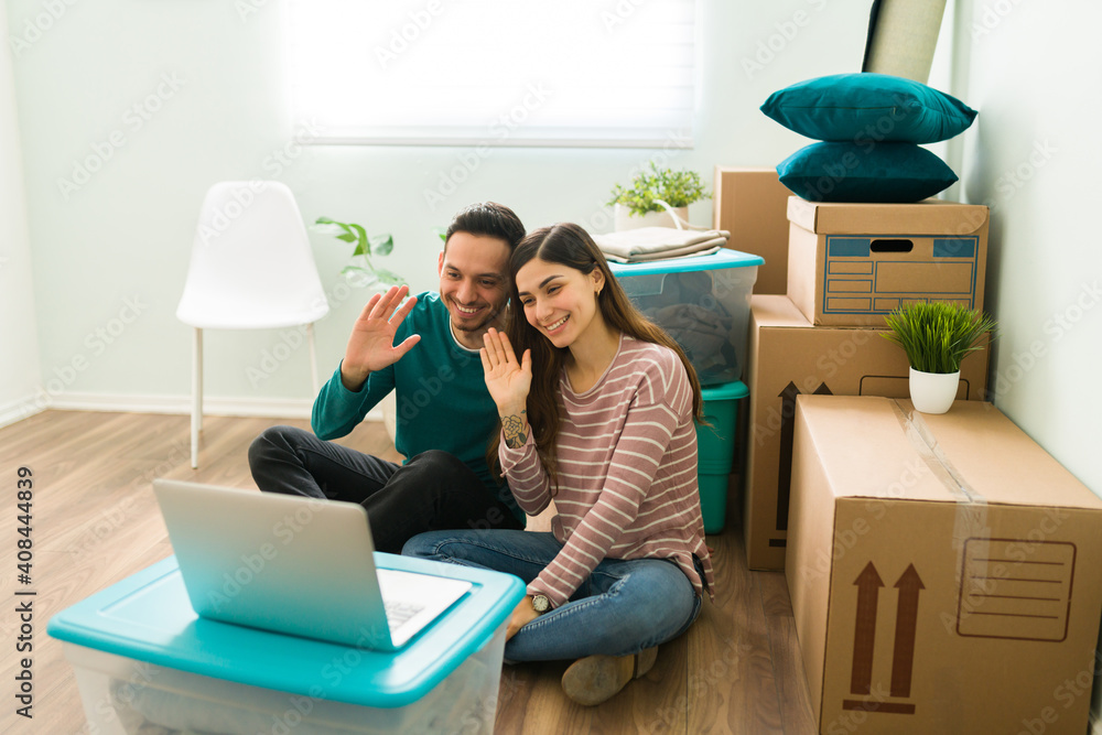 Couple having a video chat online during moving day Couple having a video chat online during moving day